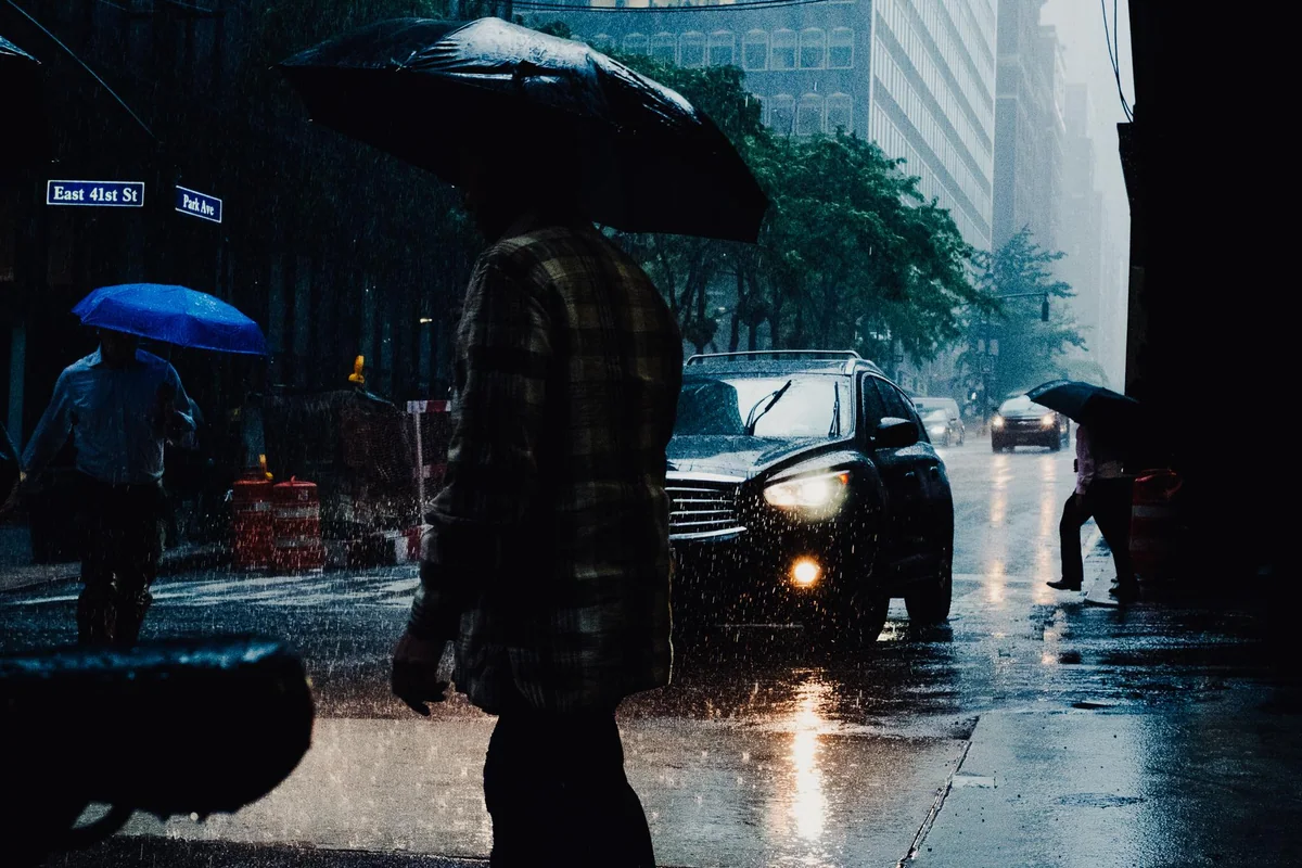 Rain, umbrellas and headlights on Park Avenue